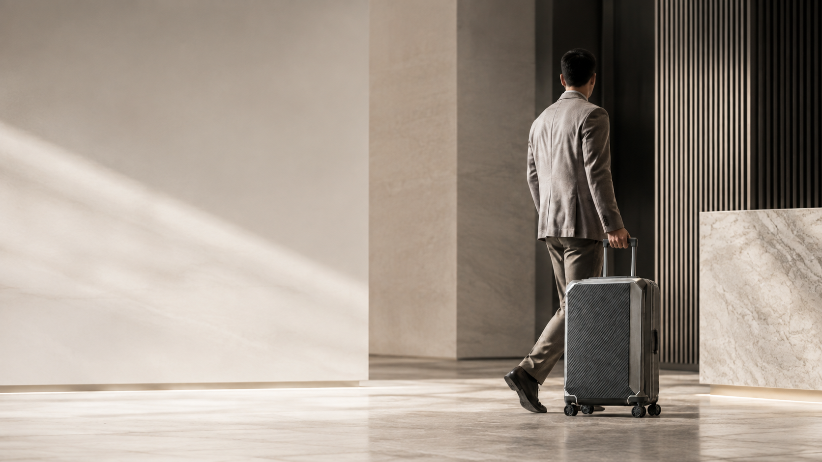 Traveler walking with a suitcase in a refined modern interior